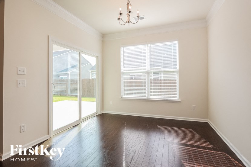 a living room with wood floors and a large window