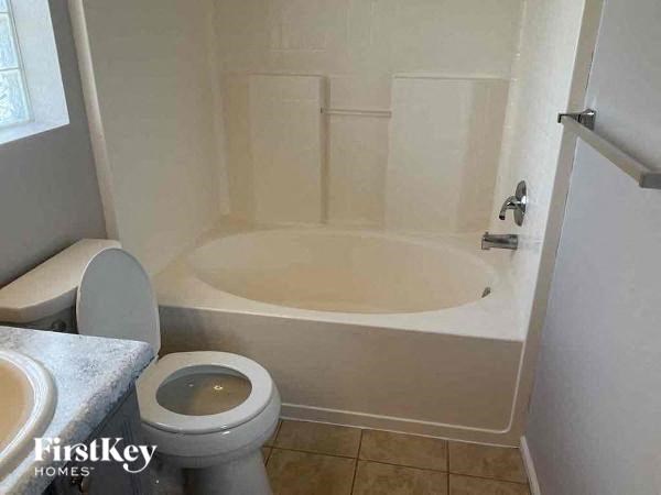 a small bathroom with a toilet and a bath tub