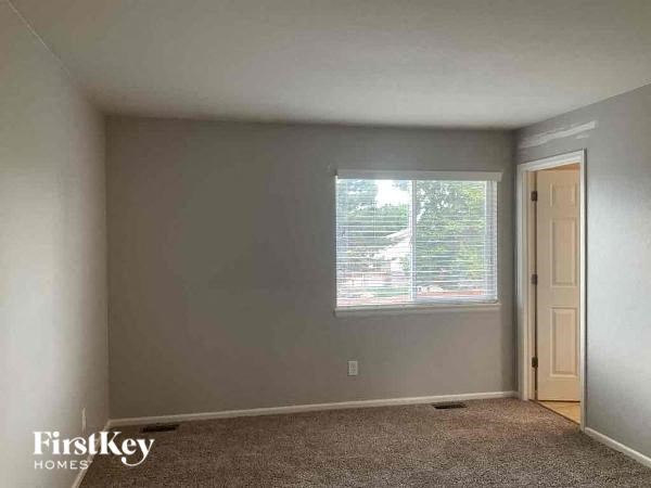 an empty room with a window and a door