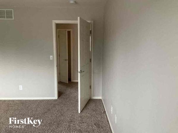 a empty room with a door open to a hallway