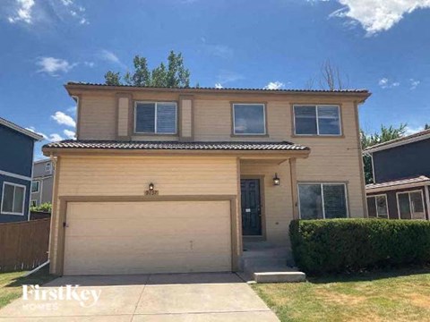 a tan house with a garage door