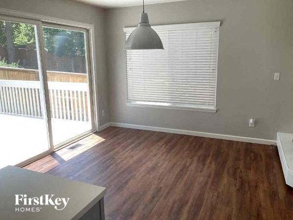 a living room with a wood floor and a sliding glass door