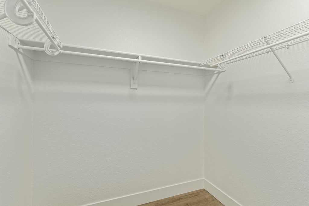 A white closet with a metal rack.