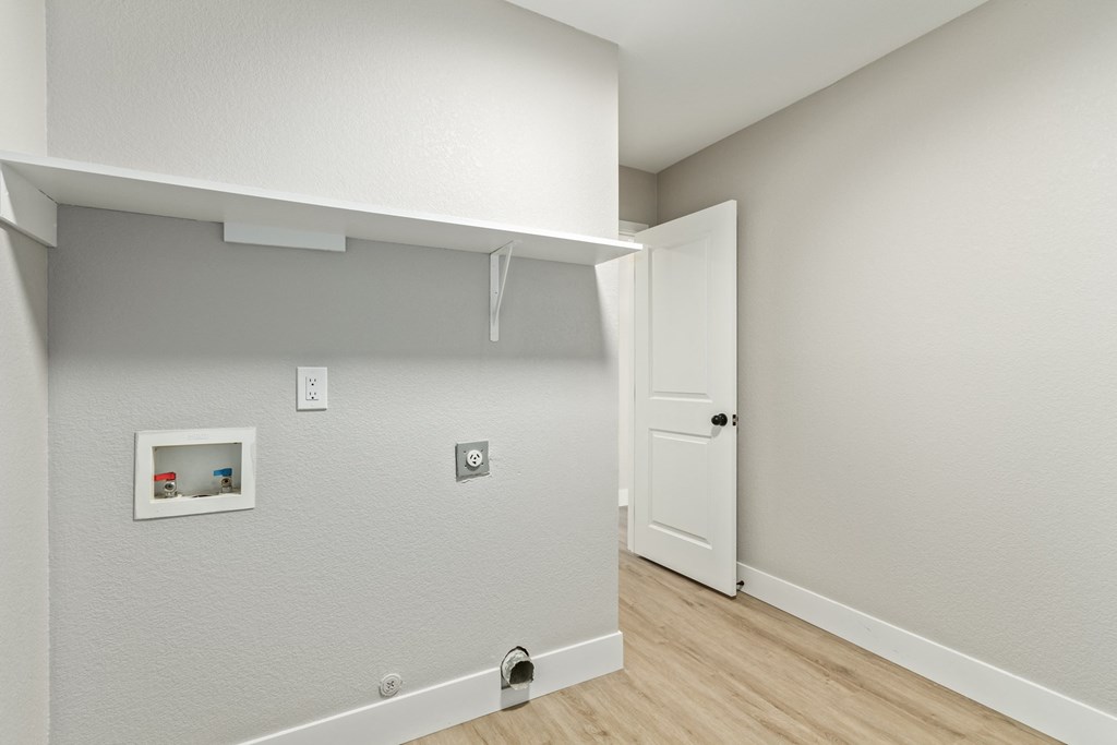 A white door is open to a hallway.