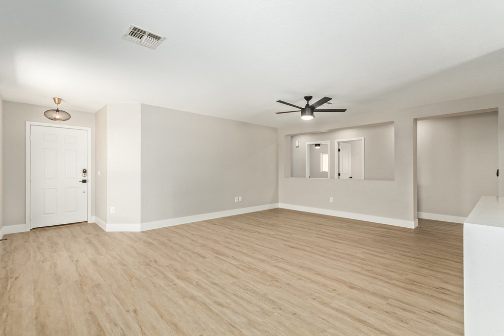 A room with a ceiling fan and light fixture.