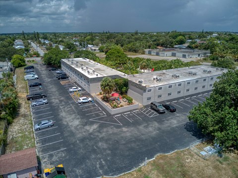an aerial view of an empty parking lot and a building
