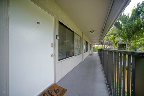 the corridor to the apartments is long and has a railing