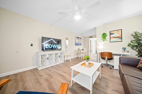 a living room with a white table and a television