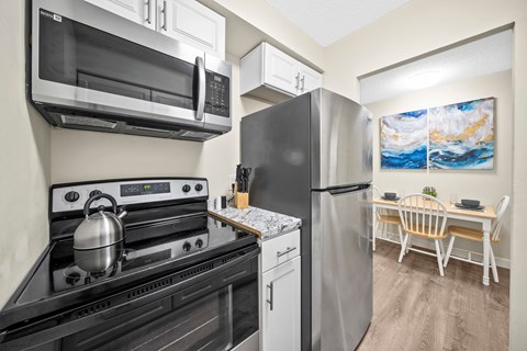 a kitchen with stainless steel appliances and a refrigerator