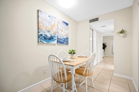 a dining room with a table and chairs