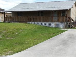 a house with a yard and a sidewalk in front of it