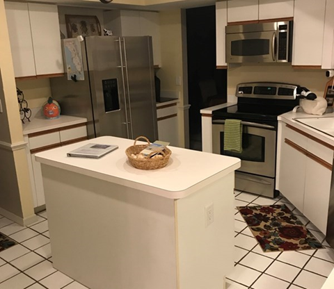 a kitchen with a counter and a refrigerator