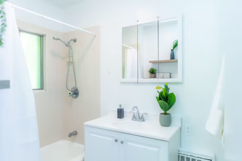 a white bathroom with a sink and a mirror