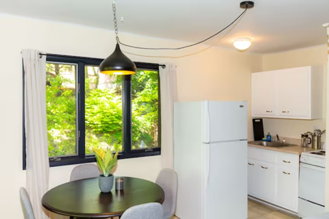 a kitchen with a green table and a white refrigerator