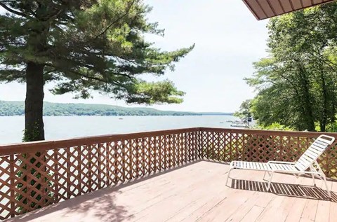 a deck with a chair and a view of the water