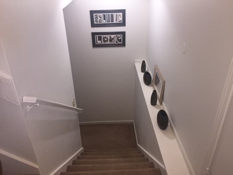 A staircase with a sign that says "Smoke Alarm" and "Fire Alarm".