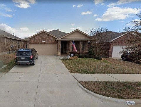 a car parked on a driveway in front of a house