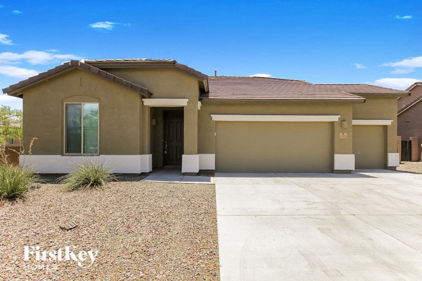 a brand new house with a driveway and a roof