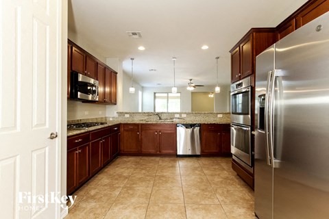 a kitchen with stainless steel appliances and wooden cabinets