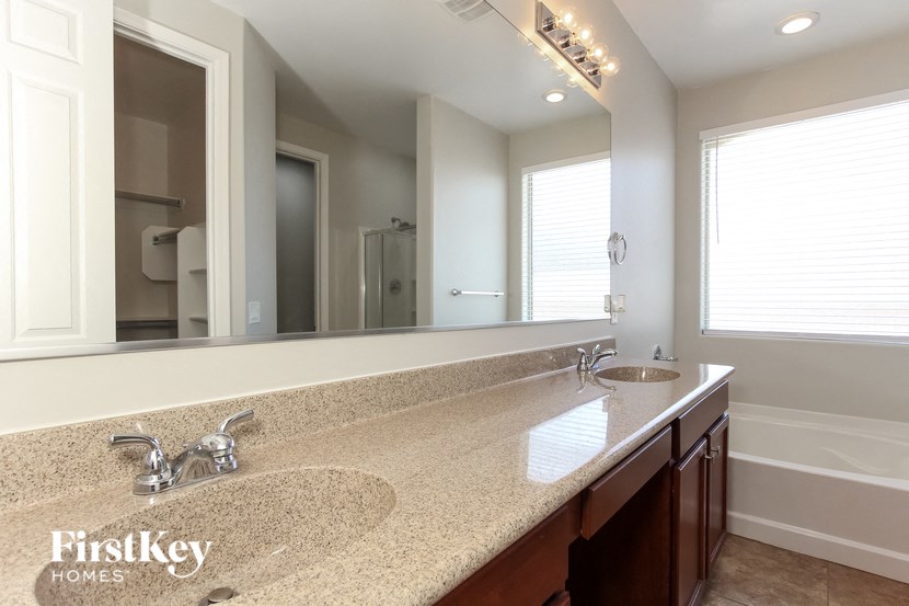 a bathroom with two sinks and a large mirror