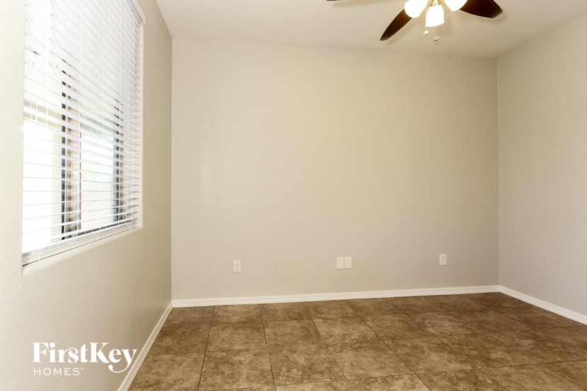 a empty room with a window and a ceiling fan