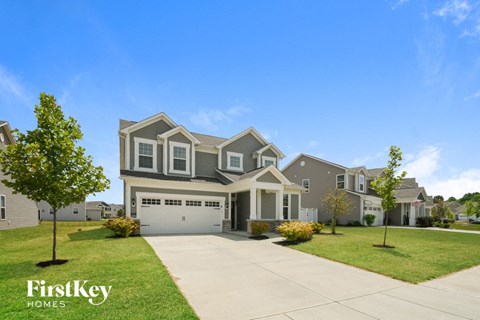 a house with a driveway and a lawn
