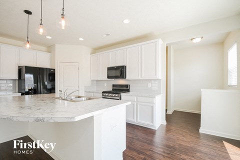 a kitchen with white cabinets and a white counter top