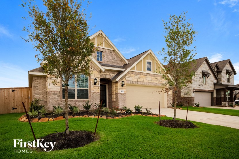 a home with two trees in the front yard