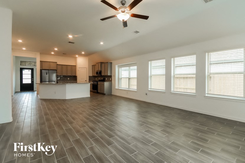 the living room is open to the kitchen and dining room