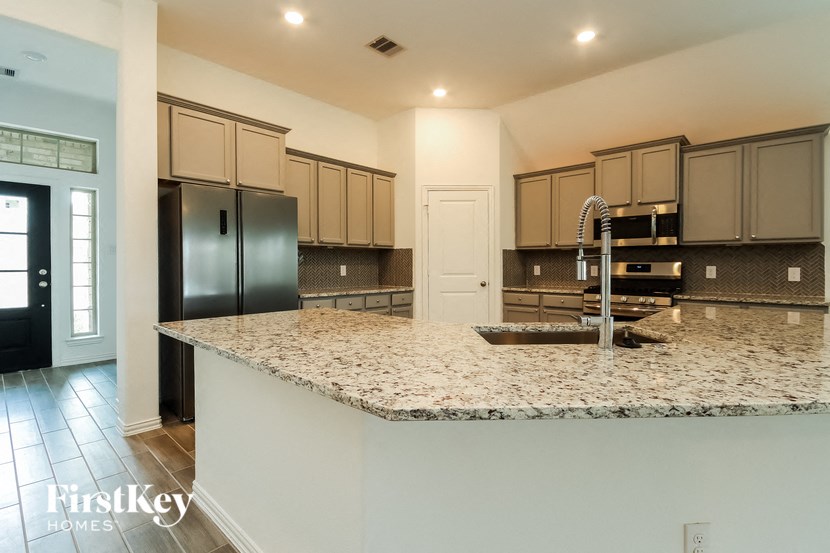 a kitchen with a granite counter top and a sink