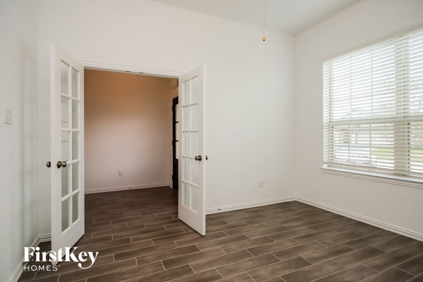 a bedroom with a door to a closet and a window