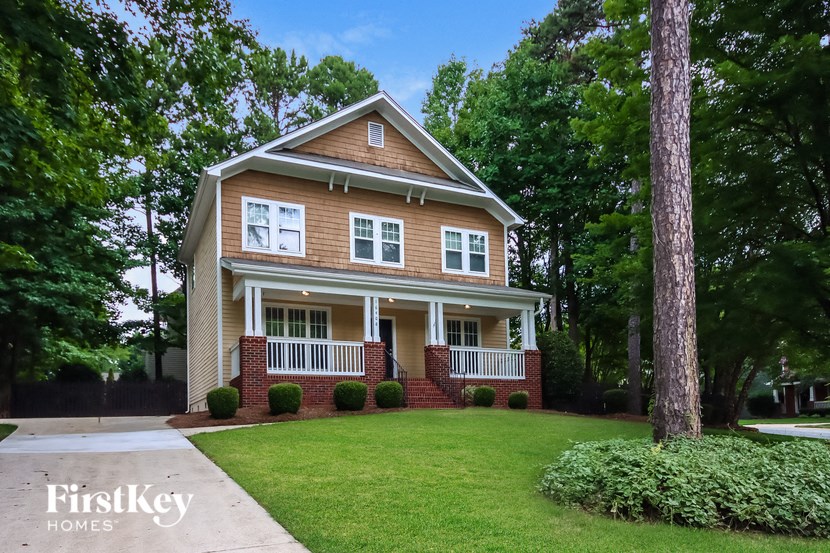 a home with a large lawn and a porch