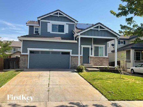 A two-story house with a garage is for sale.