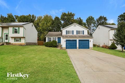 a white house with a blue garage door