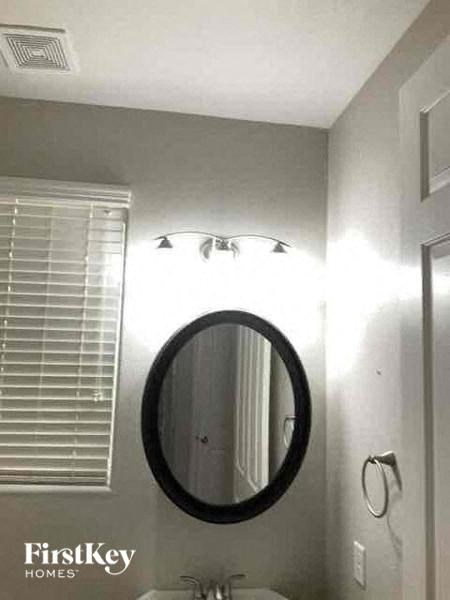 a bathroom with a mirror and a light in it
