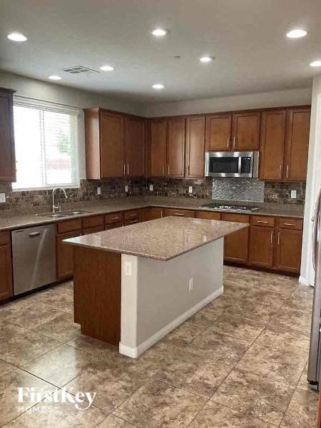 a kitchen with an island in the middle of it