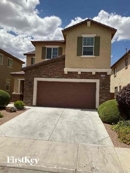 a driveway in front of a house with a garage door