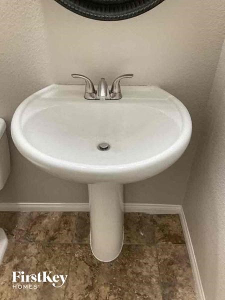 a white sink in a bathroom with a mirror