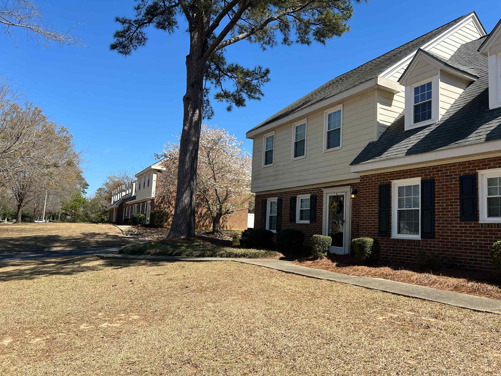 A house with a tree in front of it.