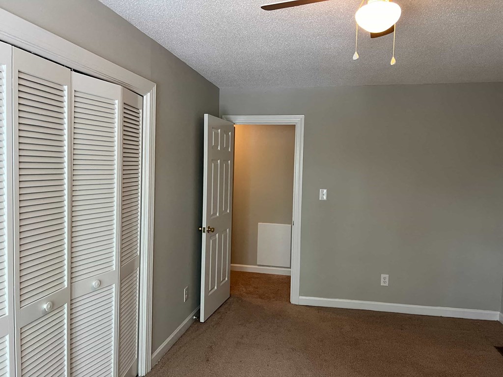 A room with a white door and a white wall.