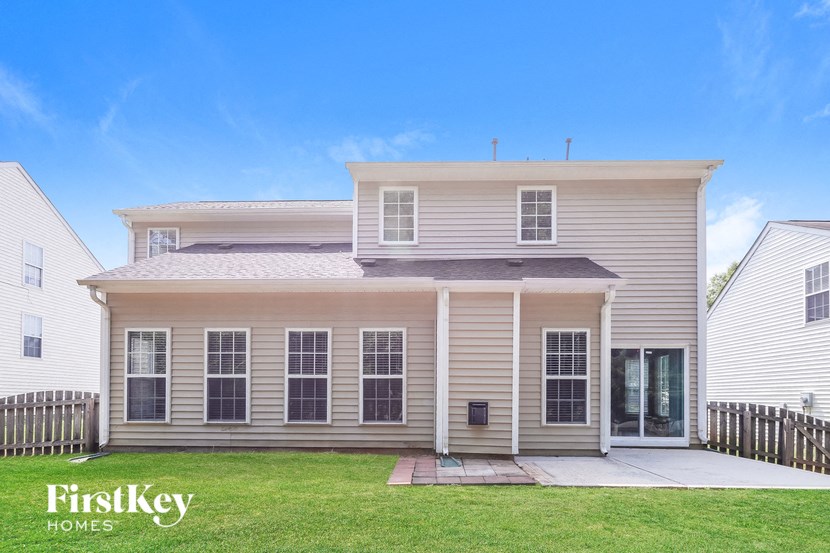 a white house with a lawn in front of it