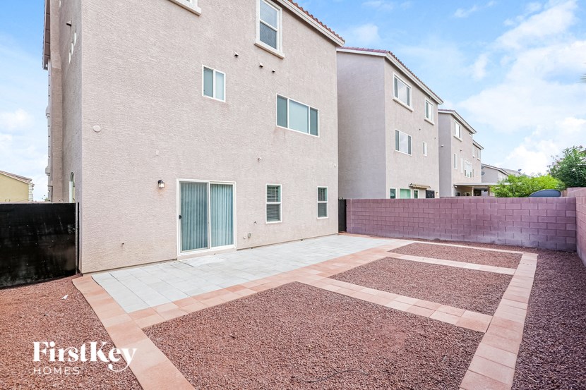 A building with a red brick courtyard in front of it.