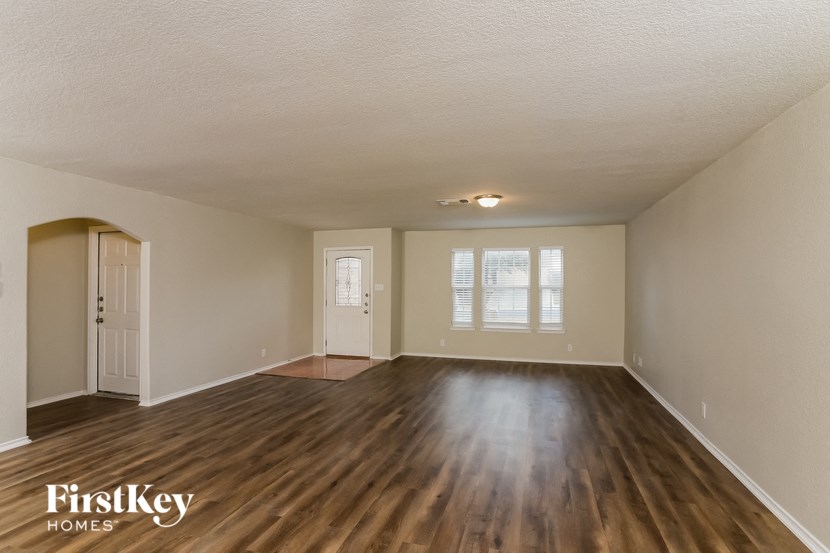the living room and dining room of an empty house