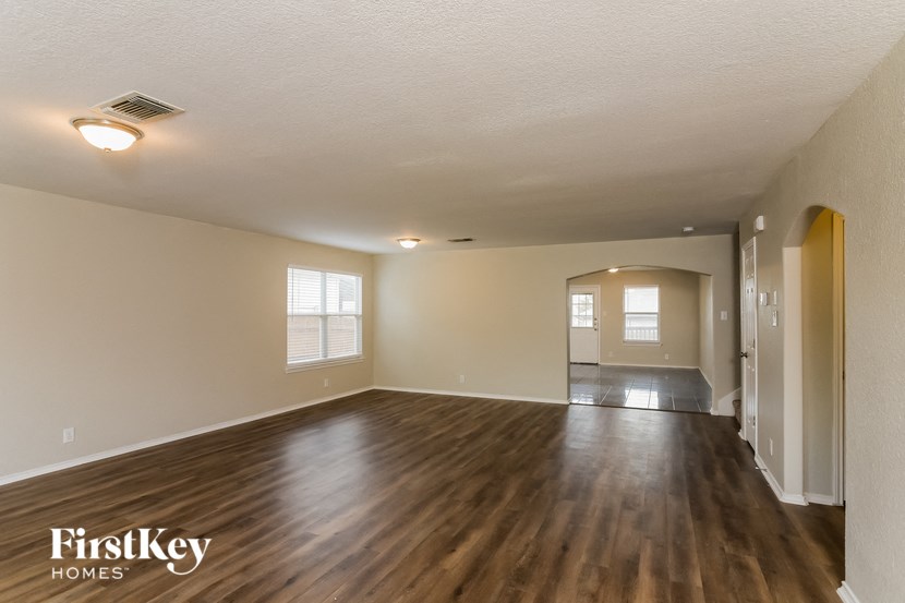 the living room and dining room of an empty house