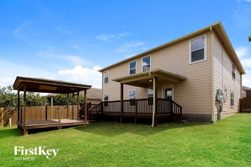 a house with a wooden deck and a gazebo