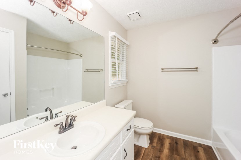 a bathroom with a sink and a mirror and a toilet