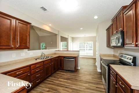a kitchen with wooden cabinets and stainless steel appliances