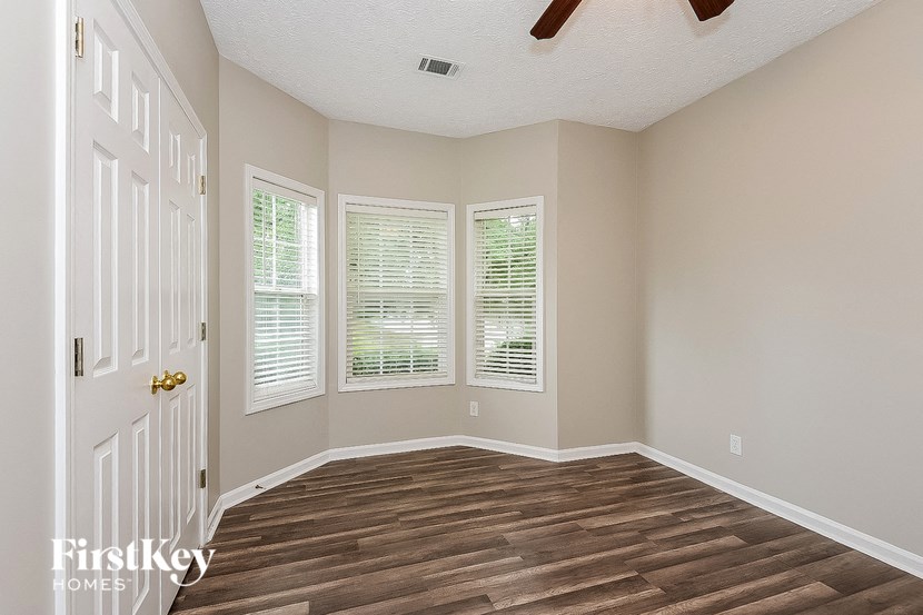a living room with wood floors and a white door