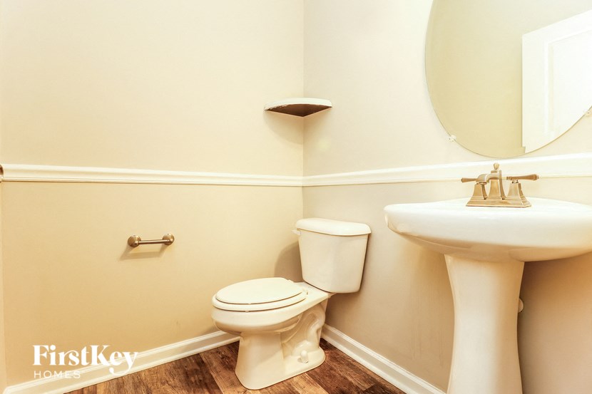 a bathroom with a toilet and a sink and a mirror