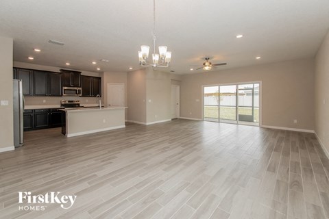 A spacious kitchen with a refrigerator, microwave, and oven.